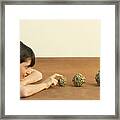 Woman Resting Head On Arms, Looking At Balls Of String, Side View Framed Print