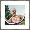 Young Blond Boy Riding A Tricycle In A Park Framed Print