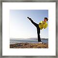 Young Woman Practicing High Kick On Shore Framed Print