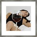 Young Woman Sleeping With Wineglasses In Front Of Her Framed Print