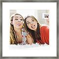 Young Women Taking Photo Of Themselves Framed Print