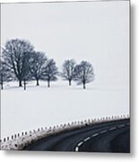 A Road Curving By A Snow Covered Field Metal Print