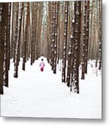 A Young Girl Walking Down A Snow Packed Metal Print