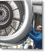 Aircraft engineer working on 737 jet engine in airport Metal Print