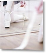 Ballerina Putting On Ballet Slippers Metal Print