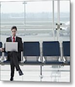 Businessman In Airport With Laptop And Mobile Phone Metal Print