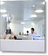 Businesswoman Holding Trophy Over Office Cubicle Metal Print