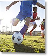 Close Up Of Boy Kicking Soccer Ball Metal Print