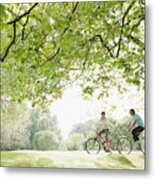 Couple Riding Bicycles Underneath Tree Metal Print