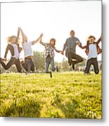 Group Of People Jumping On The Park At Dusk Metal Print