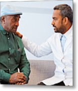 Male Doctor Consoling Senior Patient At Hospital Metal Print