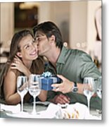 Man Kissing And Giving Gift To Woman In Restaurant Metal Print
