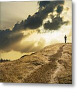 Man Walking Under Dramatic Clouds Over Grassy Rural Hill Metal Print