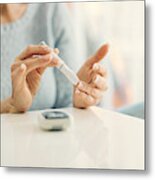 Mature Woman Doing Blood Sugar Test At Home. Metal Print