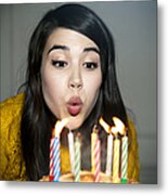 Mixed Race Woman Blowing Out Birthday Candles Metal Print