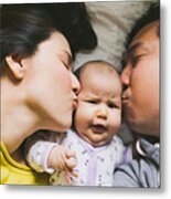 Parents Kissing Baby Metal Print