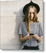 Portrait of fashionable young woman wearing hat using smartphone Metal Print