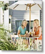 Senior Woman And Young Woman Drinking Ice Tea Out On Porch Metal Print