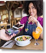 Smiling Woman Using Mobile Payment In Restaurant Metal Print