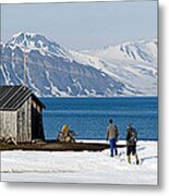 Two Hikers Standing On The Beach Metal Print