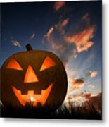 Halloween Pumpkin Glowing Under Dark Sunset, Night Sky. Jack O'lantern Metal Print