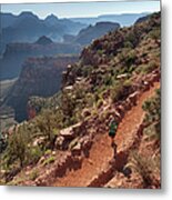 A Man Hiking On A Trail With Canyons In Metal Print