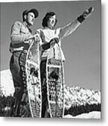 Couple Holding Snowshoes, Woman Pointing Metal Print