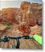 Cropped Hands Of Hiker Holding Handlebar While Mountain Biking At Desert Metal Print