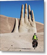 Cyclist Heading To Hand Of The Desert In Atacama Desert, Chile Metal Print
