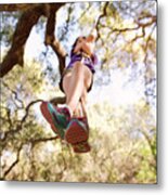 Low Angle View Of Girl Playing On Rope Swing In Forest Metal Print