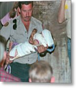 Rescuer Running With Baby Jessica Metal Print
