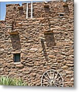 Wooden Cartwheel Against Brick Building Metal Print