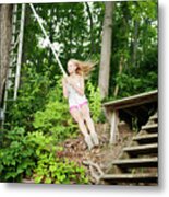 Young Woman Swinging On Rope By Staircase In Forest Metal Print
