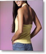 A Young Attractive Ethnic Girl With Long Dark Straight Hair A Yellow Halter Top And Denim Shorts Looks Over Her Shoulder To Smile At The Camera Metal Print