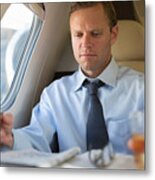 Businessman Doing Crossword On Airplane Metal Print