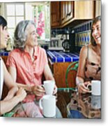 Caucasian Mother And Daughters Drinking Coffee In Kitchen Metal Print