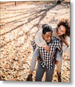 Cheerful African American Couple Piggybacking In Autumn At The Park. Metal Print