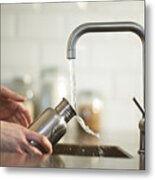 Cleaning A Plastic Free Reusable Water Bottle In Kitchen Sink. Metal Print