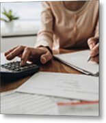 Close Up Of Woman Planning Home Budget And Using Calculator. Metal Print