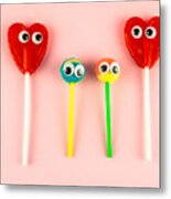 Concept Of Love And Family. Two Red Heart Lollipops With Eyes Looking At Each Other And Two Smaller Lollipops Metal Print