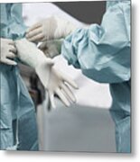 Female Doctor Helping Surgeon Wearing Glove Metal Print