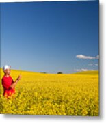 Field Of Canola Crops With Farmer Metal Print