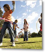 Five Children (7-12) Playing With Plastic Hoops In Park Metal Print