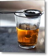 Glass Filled With Hot Tea From A Strainer Filled With Tea Leaves On Top On A Gray Marble Tabletop. Metal Print