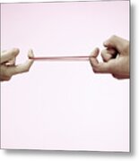 Hands Pulling Rubber Band Metal Print