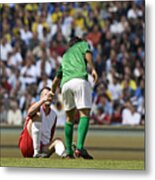 Male Soccer Player Assisting Opponent After Tackle, In Stadium Metal Print