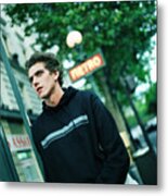 Male Teenager Under A Blurred Subway Sign Metal Print