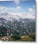 Man With A Backpack Looks At The Dachstein Massif Metal Print