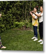 Mixed-race Sisters Being Filmed By Mother In Backyard. Metal Print