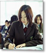 Schoolgirl Writing At A Desk In A Classroom Metal Print